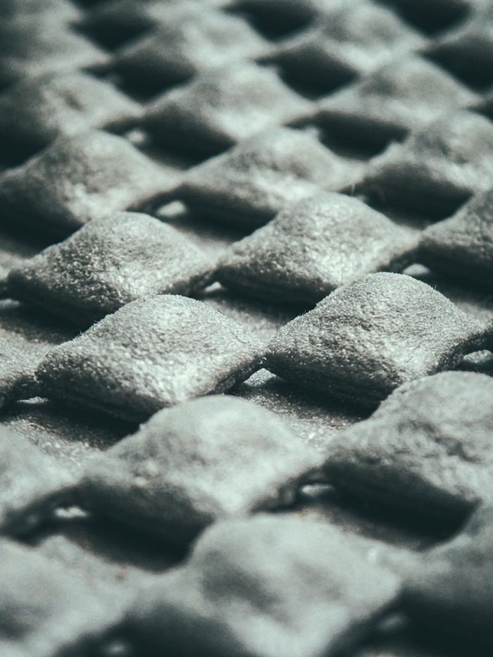 Detailed texture and pattern of a grey convex surface captured in a close-up shot.