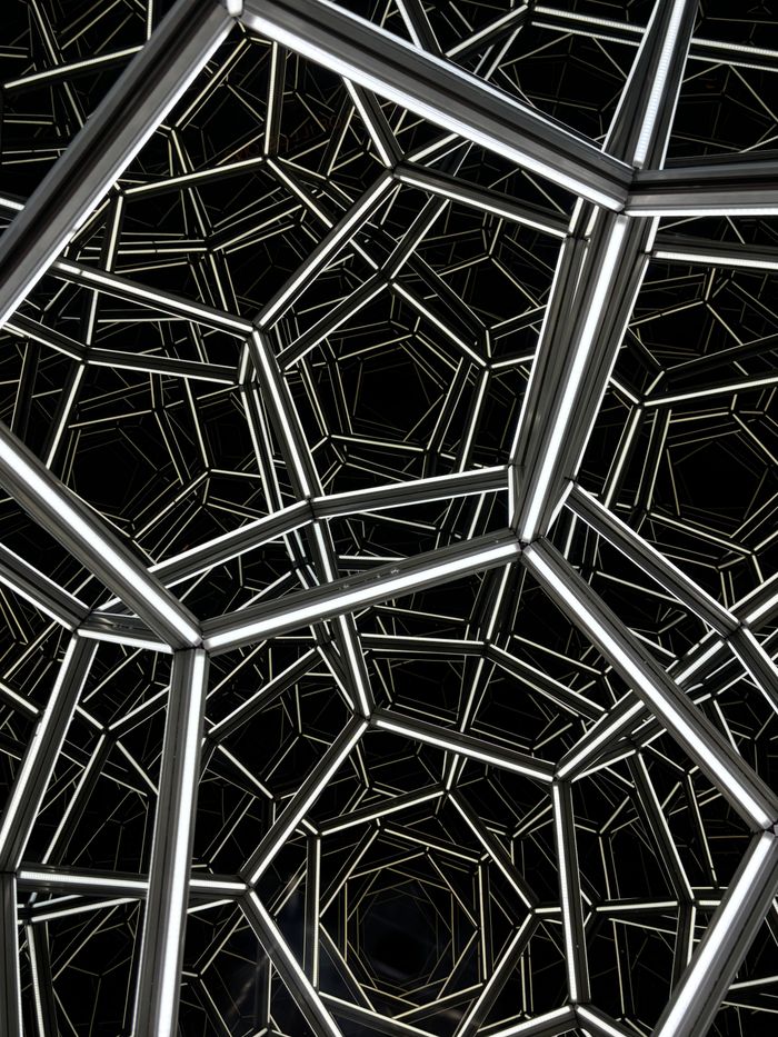 Intricate metallic geometric design forming an abstract pattern at night in Las Vegas.