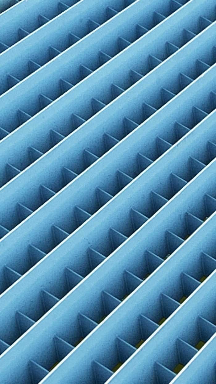 Close-up of a blue metallic grate with a symmetrical grid pattern, adding industrial appeal.